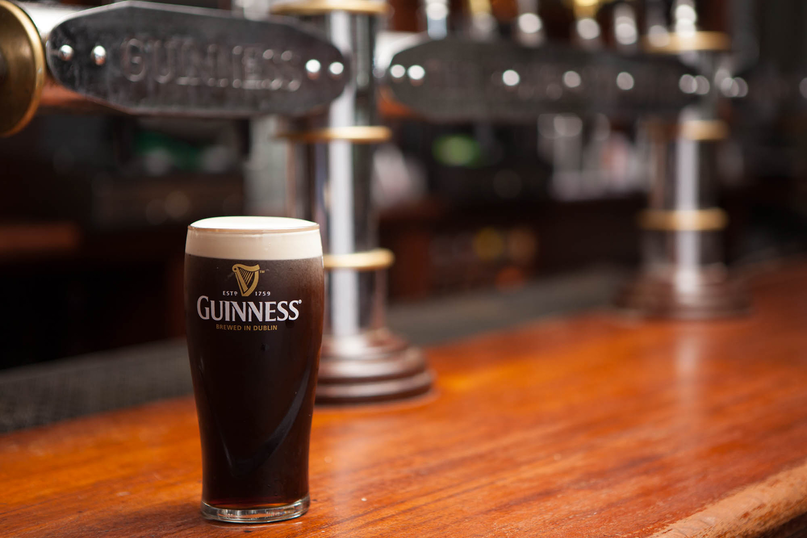 A perfectly poured pint of Guinness with a creamy head at The Plough and The Stars