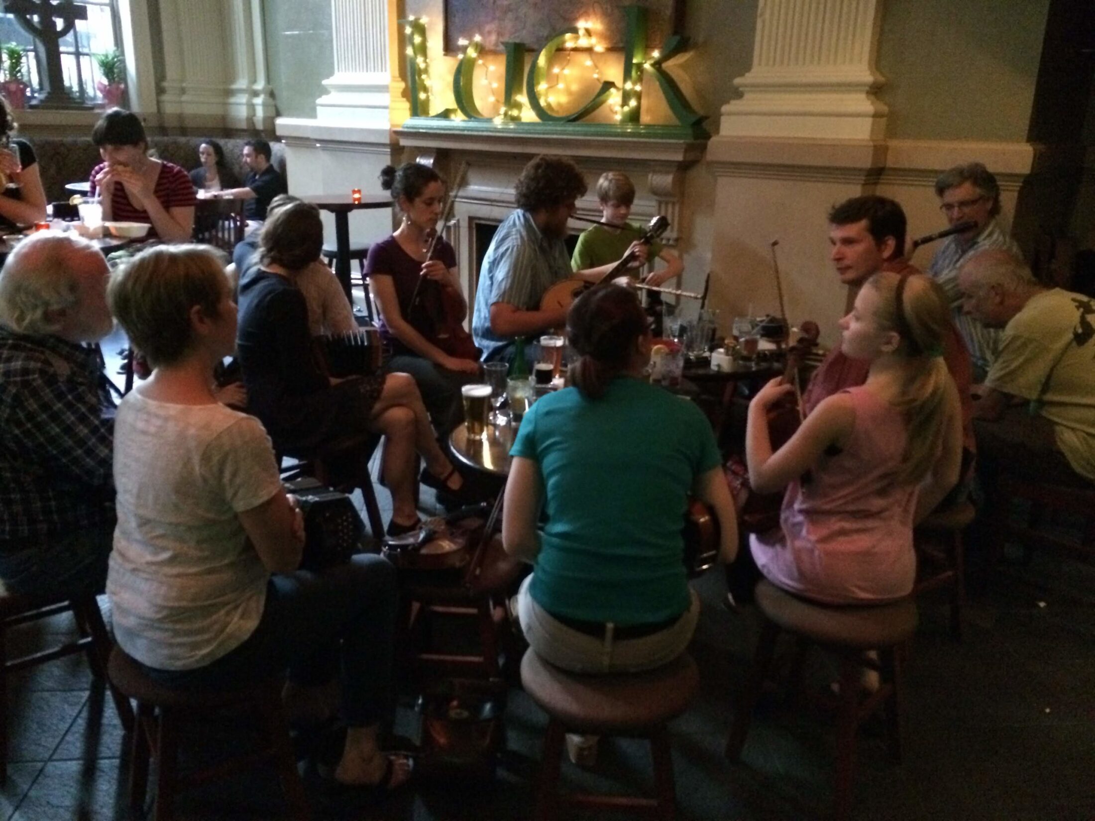 Musicians gathered for a traditional Irish music session at The Plough and The Stars